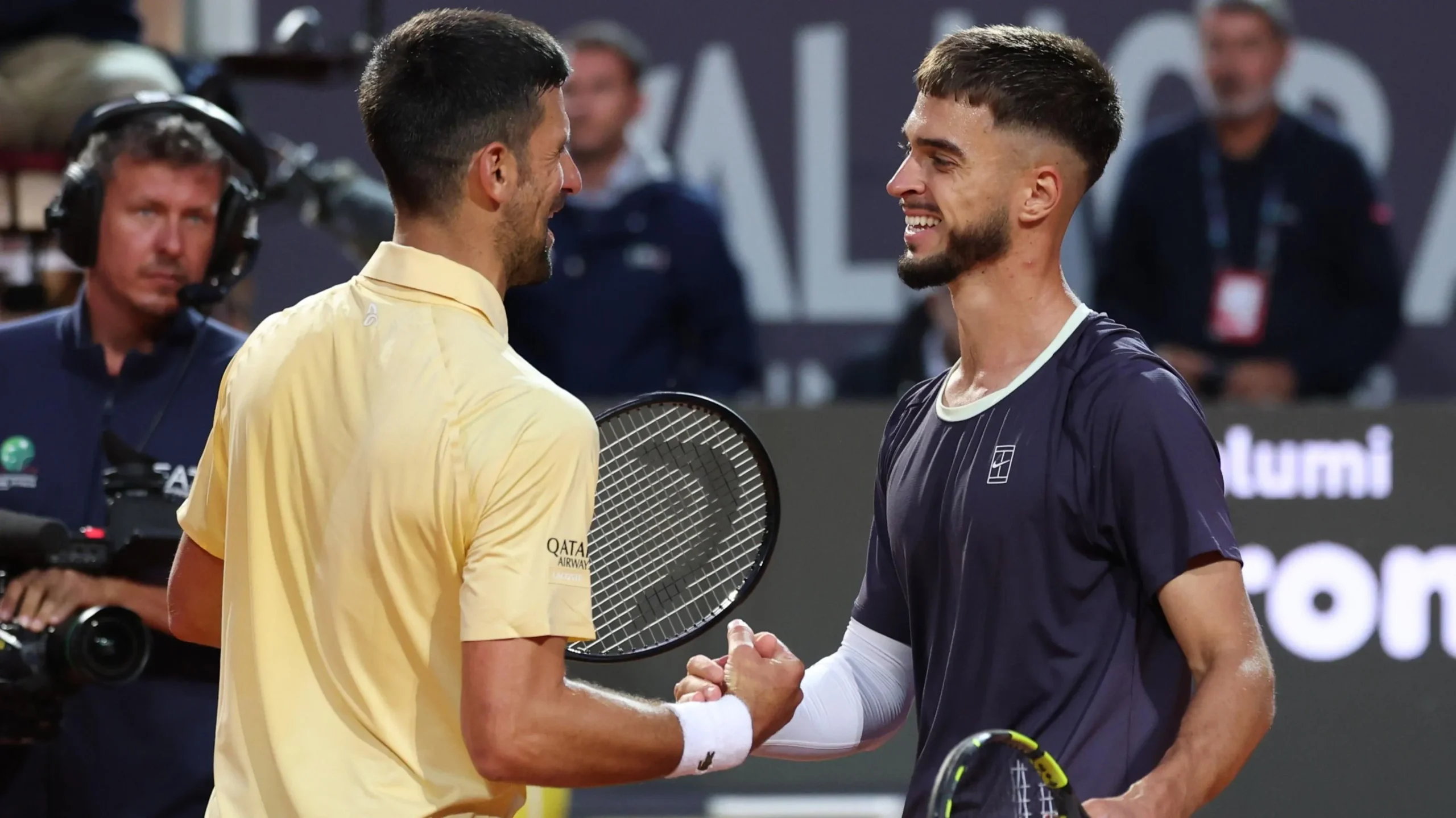 Novak Djokovic shakes hands with Dino Prizmic after the match